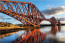 Forth-híd
A Forth-híd egy konzolos vasúti híd a skóciai Edinburgh közelében egy tengeröböl felett. Teljes hossza 2528 méter, és 46 méteres magasságban található. A híd 1890-ben nyílt meg a forgalom számára, és sokáig a világ leghosszabb vasúti hídja volt. Naponta 190-200 vonat halad át rajta, a híd pedig az Edinburgh és Inverness közötti fővonalon található, amely vonal gyakorlatilag az összes észak-skóciai nagyvárost érinti, így igen komoly forgalmat bonyolít le.
Forth-híd
A Forth-híd egy konzolos vasúti híd a skóciai Edinburgh közelében egy tengeröböl felett. Teljes hossza 2528 méter, és 46 méteres magasságban található. A híd 1890-ben nyílt meg a forgalom számára, és sokáig a világ leghosszabb vasúti hídja volt. Naponta 190-200 vonat halad át rajta, a híd pedig az Edinburgh és Inverness közötti fővonalon található, amely vonal gyakorlatilag az összes észak-skóciai nagyvárost érinti, így igen komoly forgalmat bonyolít le.